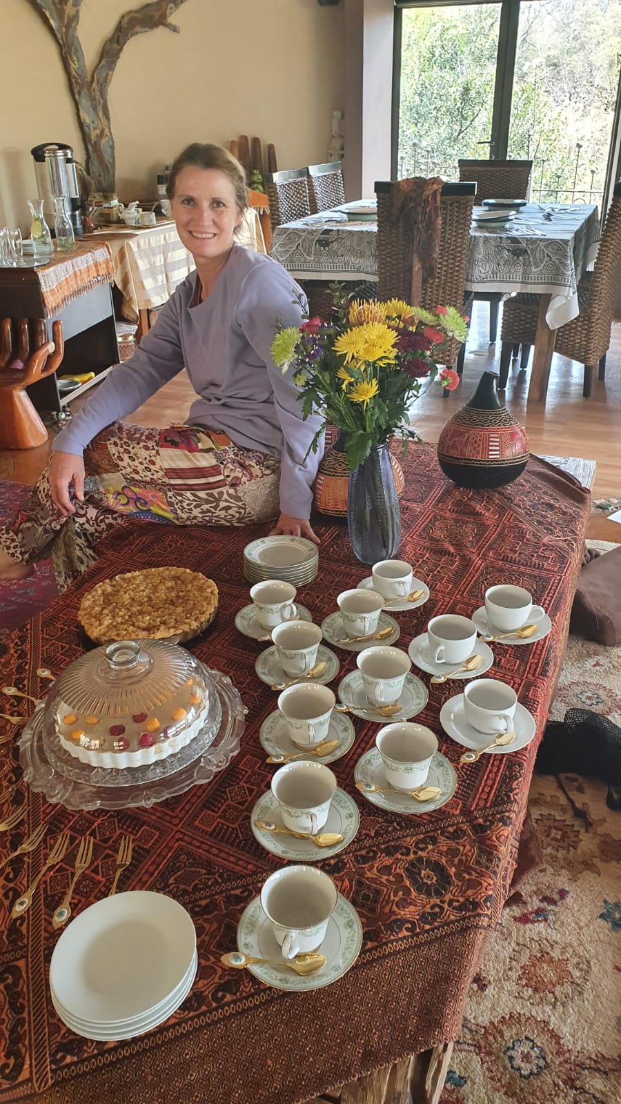 A table laid with tea cups, cake and flowers at one of our retreats