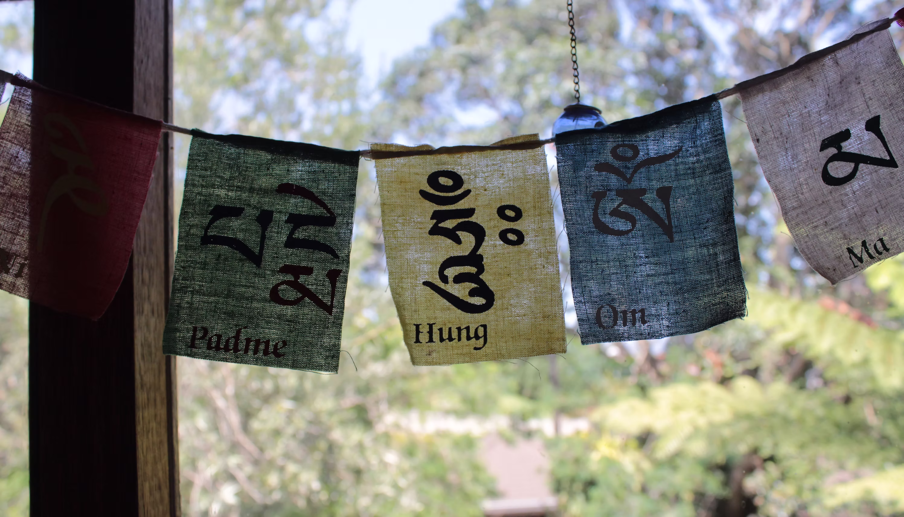 Colorful prayer flags adding spiritual ambiance to the Eagles View Yoga studio space